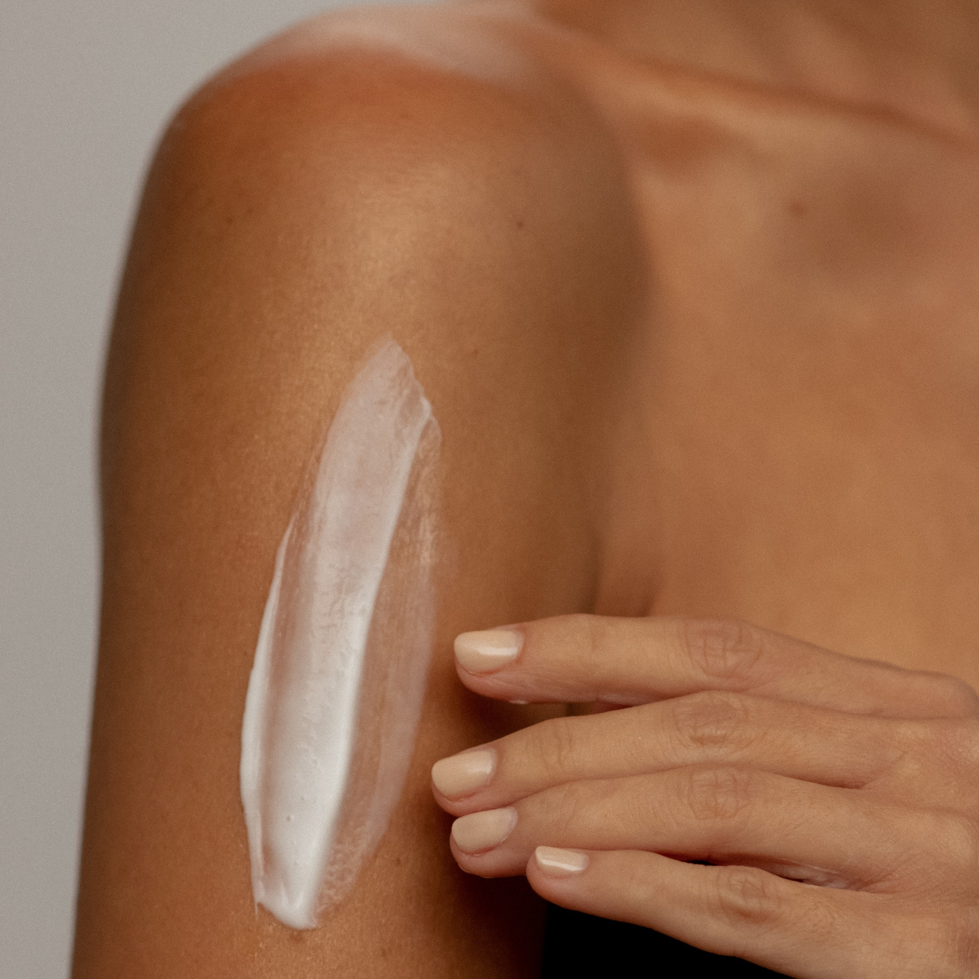A smear of Eco By Sonya Coconut Body Milk organic moisturiser on arm showing creamy texture.