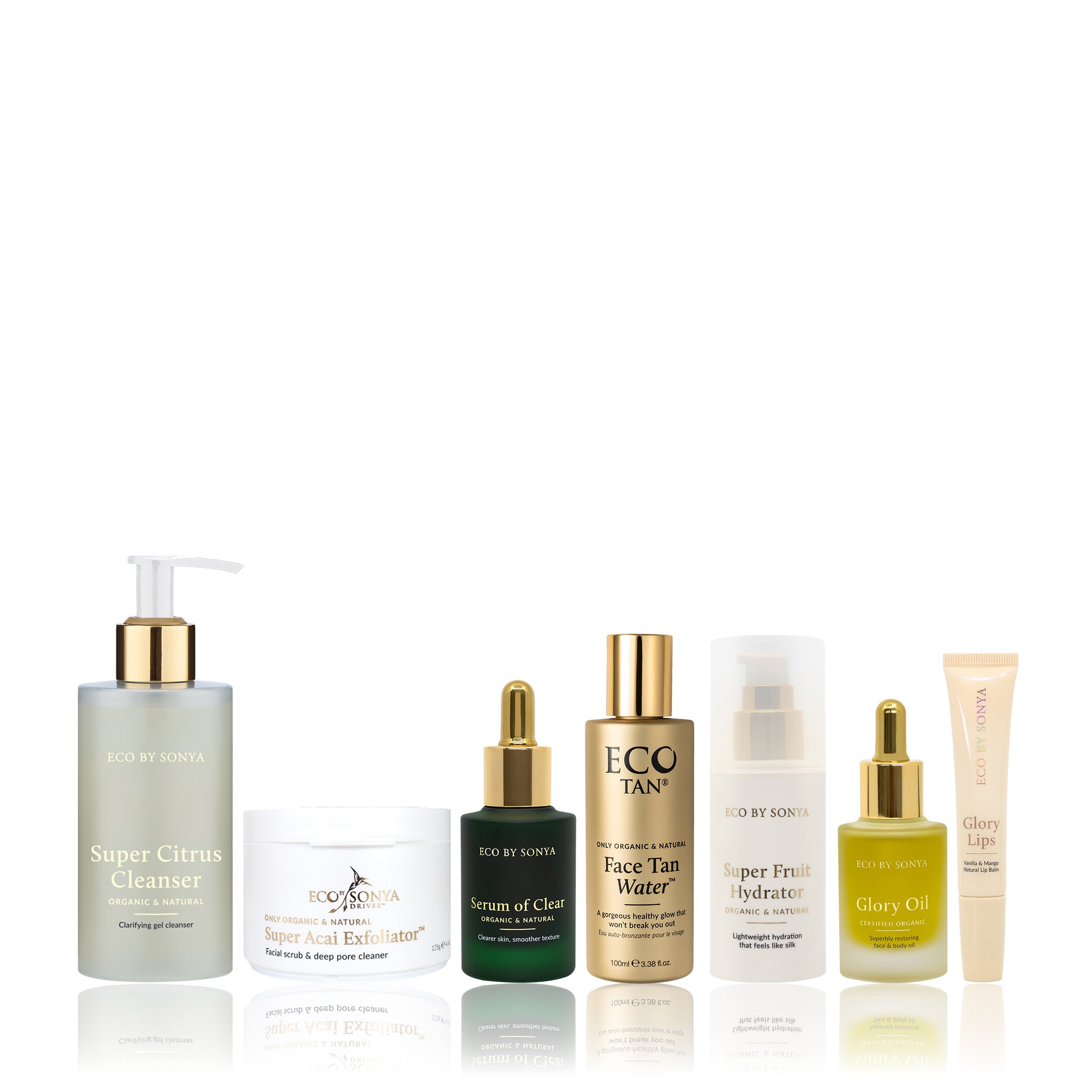 A collection of Eco By Sonya Clear Skin System products, including cleanser, serum, oil, Face Tan Water, hydrator, exfoliator and bonus lip balm, arranged together on a clean background.
