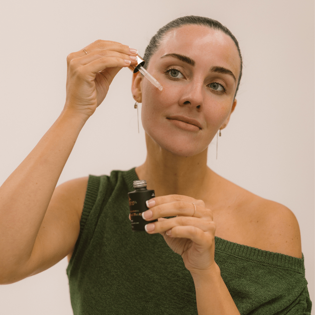 Woman applying Eco by Sonya natural vitamin C Serum of Plenty to skin