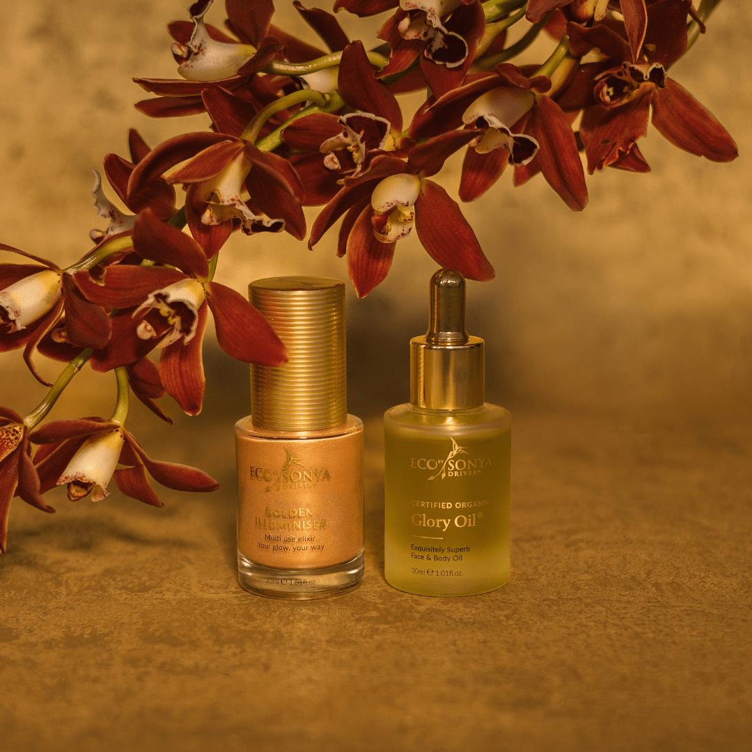 Eco by Sonya  Glory Oil and Golden Illuminiser on gold background with orchids